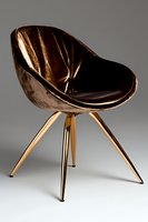 Modern copper metallic chair with curved seat shell and geometric tripod base against gray background, luxury furniture design for contemporary interiors.