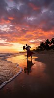 Romantic couple silhouette dancing on tropical beach at sunset with dramatic orange and purple sky clouds reflecting on wet sand and ocean waves.