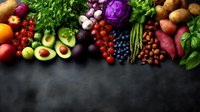 Fresh colorful fruits and vegetables arranged in rainbow pattern on dark background. Raw organic produce with copy space for healthy eating concept.
