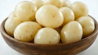 Fresh small potatoes in wooden bowl on white background isolated for cooking and food preparation designs.