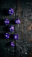 Purple polyhedral dice set with white numerals arranged on weathered dark wood surface for tabletop gaming and role-playing campaigns.
