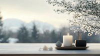 Serene meditation setup with white candle, incense holder and crystals on windowsill against snowy mountain landscape and blooming tree branches at dawn.