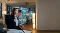 Professional businesswoman analyzing holographic data visualization in modern office environment for corporate technology presentations.