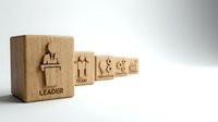 Wooden blocks with business hierarchy icons showing leader, team, and employee symbols arranged in organizational structure on white background.