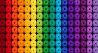 Colorful rainbow gradient pattern of hexagonal shapes arranged in rows creating vibrant spectrum from red to purple for backgrounds and design projects.