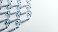 Modern glass chain links casting geometric shadows on white surface creating abstract pattern for contemporary design projects.