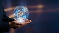 Businessman holding glowing sphere with digital security icons including gears, target, shield and lock symbols representing cybersecurity and data protection.