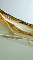 Golden liquid waves flowing smoothly with reflective surface creating elegant curves and ripples for luxury cosmetic and skincare product backgrounds.