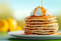 Stack of fluffy pancakes topped with whipped cream and drizzled maple syrup on white plate, golden honey flowing down against bright morning background.