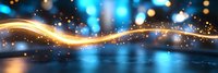 Glowing golden wave with sparkles and light particles flowing on dark background with blue bokeh lights creating magical atmosphere and motion effect.