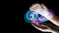 Human hands protecting glowing infinity symbol with vibrant neon colors on dark background representing eternal protection and endless possibilities.