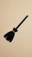 Black witch broom silhouette on beige background for Halloween decorations, crafts, and seasonal designs.