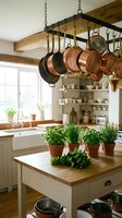 Rustic farmhouse kitchen with copper pots hanging from ceiling rack, herb plants on wooden island, exposed beams and white cabinets for cozy cooking space.