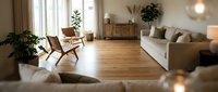 Modern minimalist living room with wooden floors, white sofa, plants and natural lighting for interior design and home decor concepts.