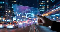 Hand holding futuristic tablet displaying 2020 with digital network connections against blurred city lights background for technology concepts.