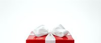 Red gift box with white ribbon bow isolated on white background, ready for holiday designs, greeting cards, and festive marketing materials.