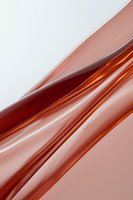 Abstract diagonal waves in copper and white tones create dynamic movement and modern minimalist composition for backgrounds and design projects.