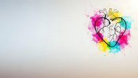 Anatomical heart with vibrant watercolor splashes in pink, yellow and blue on gradient background for medical and artistic designs.