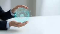 Businessman holding glowing holographic sphere with digital network connections and data analytics interface for business technology and innovation concepts.