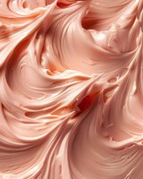 Swirling peach-colored cream texture with soft waves and curves creating an elegant abstract pattern, suitable for food photography and cosmetic advertising backgrounds.