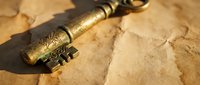 Antique brass key with ornate decorative handle lying on aged parchment paper creating vintage treasure hunting atmosphere for mystery adventure themes.