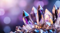Luminous crystal points with purple and blue reflections on blurred bokeh background. Magical mineral formation closeup showing natural geometric shapes.