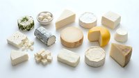 Assorted cheese varieties including soft, hard, aged, and fresh types arranged on white background for culinary and food styling projects.
