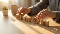 Business professional arranging wooden blocks with strategy icons on desk in warm office lighting for planning and development concepts.