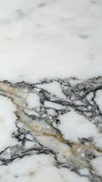 Elegant white marble surface with dramatic gray and gold veining patterns for luxury interior design and architectural applications.