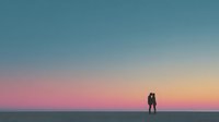 Romantic couple silhouette embracing against stunning sunset gradient sky in pink orange and blue hues creating peaceful intimate moment for love concepts.