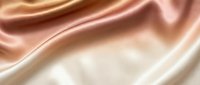 Luxurious silk fabric with smooth waves and soft folds in warm beige and rose gold tones, creating an elegant, flowing texture suitable for fashion, beauty, and luxury product backgrounds.