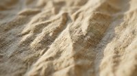 Close-up of natural linen fabric with textured weave pattern, showcasing organic fibers and neutral beige tones for textile, fashion, and interior design projects.