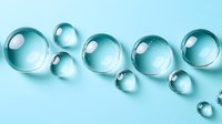 Transparent glass spheres and bubbles floating on turquoise background for modern design projects and digital art compositions.