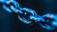 Metallic chain links in deep blue tones with water droplets and bokeh effects creating dramatic macro photography composition for business security concepts.