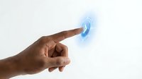 Human finger touching glowing blue digital interface button with futuristic holographic light effects on white background for technology concepts.