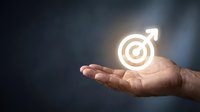 Male hand holding glowing neon male symbol with target icon, representing business goals, success, and ambition for corporate marketing and leadership concepts.