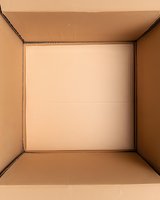 Inside view of empty cardboard box showing brown corrugated walls and bottom, minimalist composition with clean lines and natural lighting for packaging design.