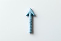 Light blue plasticine arrow pointing upward on white background, minimalist composition for business growth and success concepts.