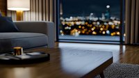 Modern luxury apartment interior with city night lights view through panoramic window, grey sofa, coffee table and bokeh effect in background.