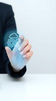 Businessman hand holding holographic cloud computing icons with gears representing digital transformation and technology integration in modern business.