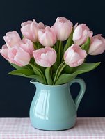 Fresh pink tulips arranged in turquoise ceramic pitcher on checkered tablecloth against dark background for spring home decor and floral arrangements.