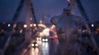 Statue covered in rain droplets at dusk with blurred city lights and bridge in background, suitable for atmospheric urban and weather-related design projects.