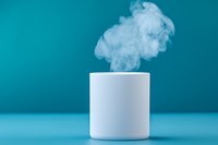 White ceramic mug with rising steam against turquoise background, minimalist composition showcasing warmth and comfort in modern setting.