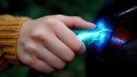 Magical electric discharge between fingers and dark surface creates glowing blue lightning effect against blurred background. Mystical energy concept for fantasy designs.