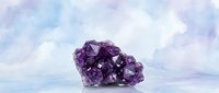 Purple amethyst crystal cluster on soft pastel background for wellness, meditation and spiritual healing practices in modern minimalist style.
