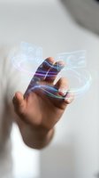 Hand holding smartphone with holographic digital interface icons and glowing data streams for mobile technology and futuristic communication concepts.