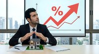 Professional businessman analyzing rising percentage growth chart in modern office with city skyline view during financial presentation meeting.