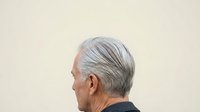 Senior man with gray hair in profile view against neutral background, suitable for healthcare, aging, wellness and lifestyle editorial use.