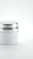 Luxury white cosmetic jar with silver lid on clean background for skincare product packaging and beauty brand marketing.