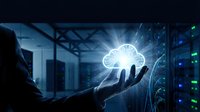 Hand holding glowing cloud computing icon in modern data center server room with blue lighting and network connectivity visualization.